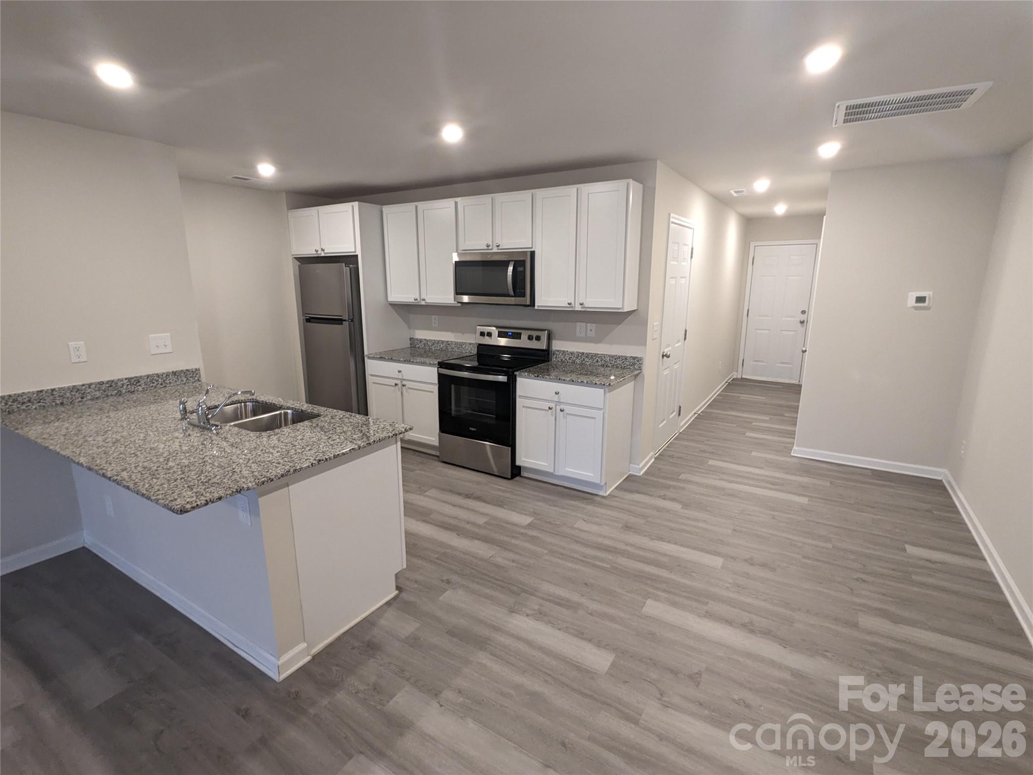 237 Century Drive Salisbury, NC 28147 - Photo 2 of 9 a kitchen with stainless steel appliances granite countertop a stove top oven a sink and a refrigerator