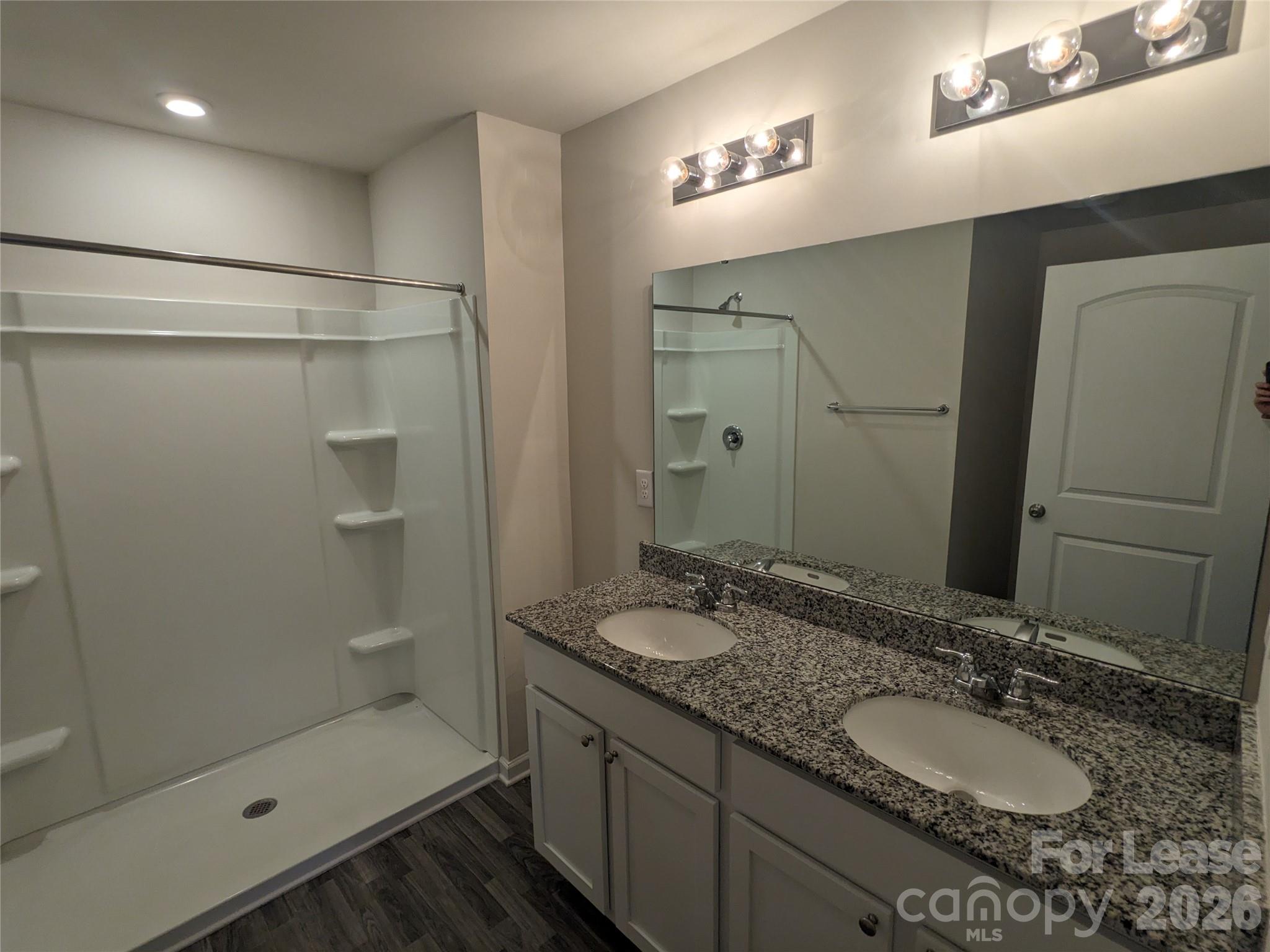 237 Century Drive Salisbury, NC 28147 - Photo 5 of 9 a bathroom with a granite countertop sink mirror and shower