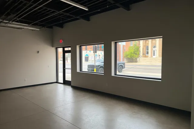 a view of a room with wooden floor and windows
