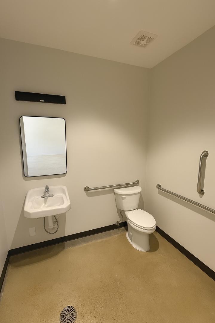 204 East Main Street Lebanon, TN 37087 - Photo 10 of 10 a bathroom with a toilet sink and mirror