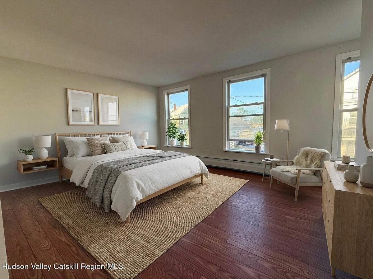 4 Frederick Street Hudson, NY 12534 - Photo 7 of 14 a spacious bedroom with a bed and wooden floor