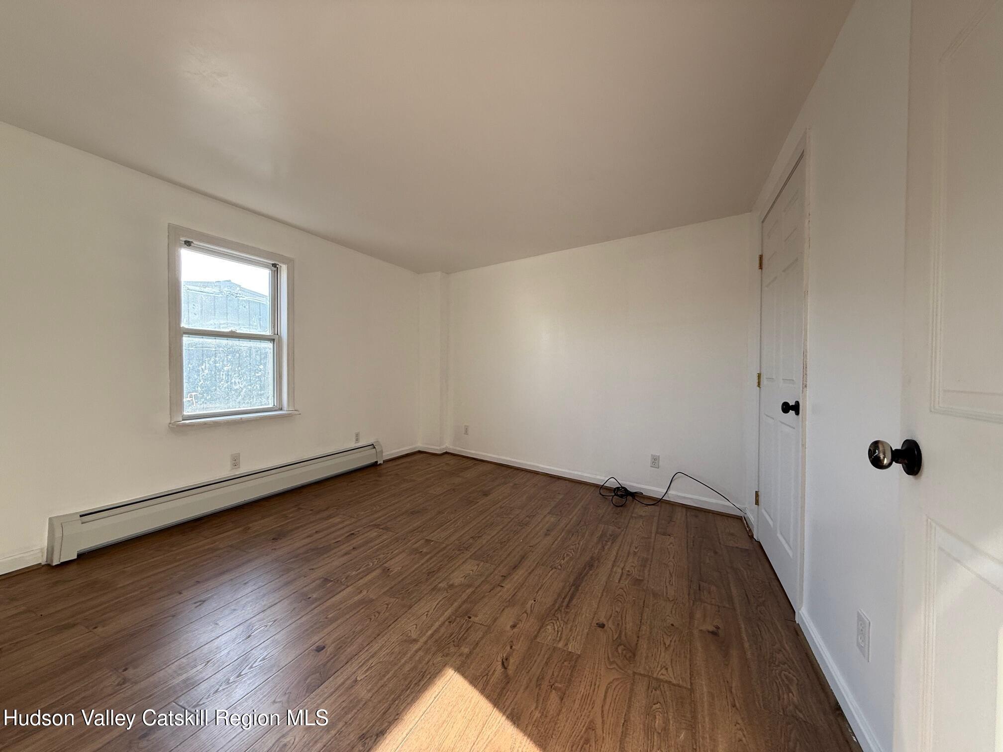 4 Frederick Street Hudson, NY 12534 - Photo 10 of 14 an empty room with wooden floor and windows