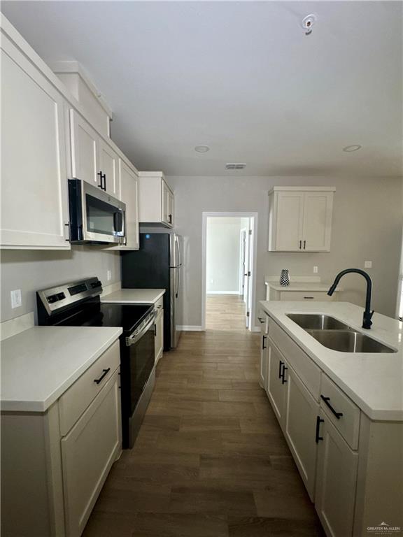 720 Ragland Road, Unit 8 Mission, TX 78572 - Photo 13 of 17 a kitchen with stainless steel appliances a sink stove top oven and white cabinets