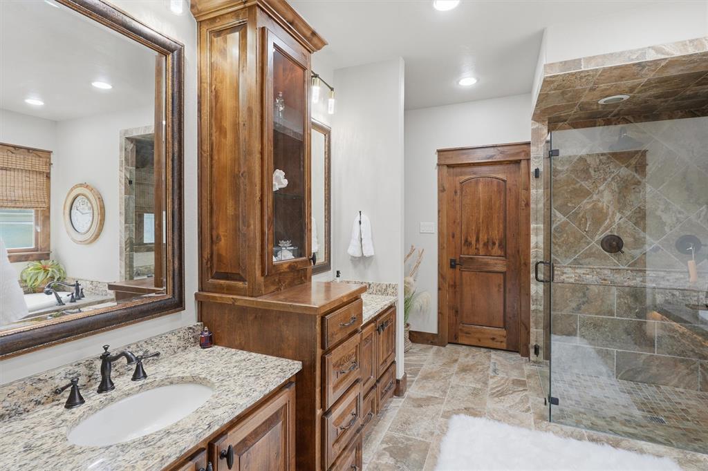 1080 Cascade Lane Graford, TX 76449 - Photo 15 of 39 a bathroom with double vanity and a mirror