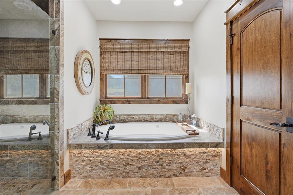 1080 Cascade Lane Graford, TX 76449 - Photo 17 of 39 a bathroom with a tub a sink and a window