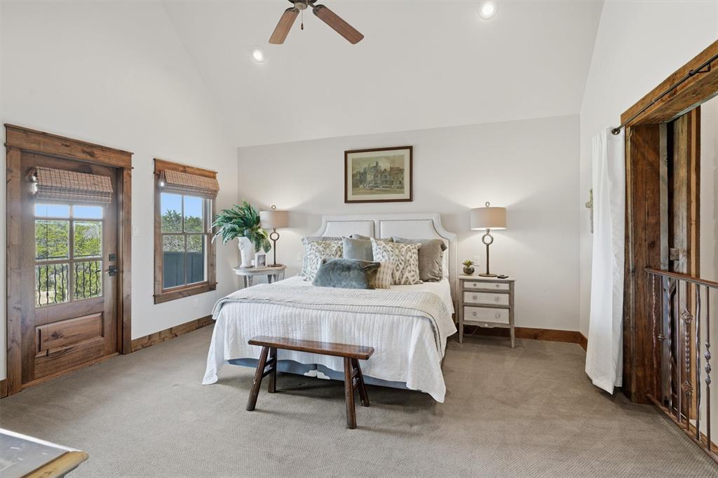 1080 Cascade Lane Graford, TX 76449 - Photo 18 of 39 a spacious bedroom with a bed and large windows