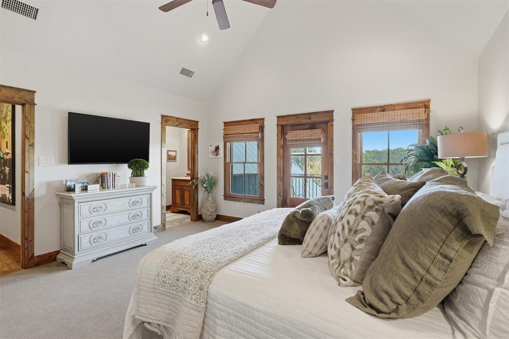1080 Cascade Lane Graford, TX 76449 - Photo 19 of 39 a bedroom with a bed and a flat tv screen on dresser