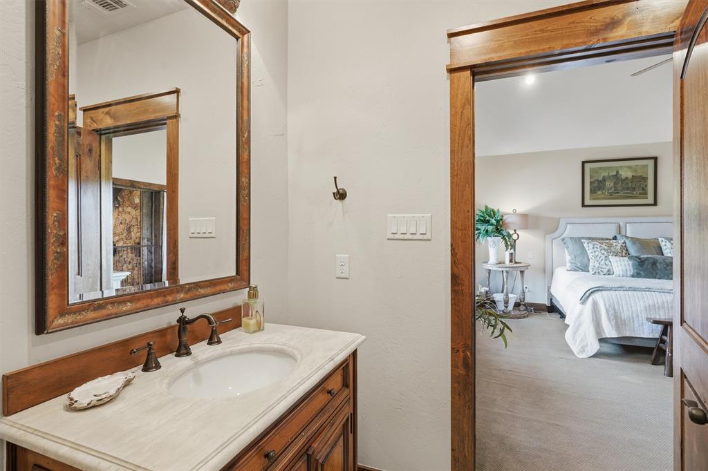 1080 Cascade Lane Graford, TX 76449 - Photo 21 of 39 a en suite bathroom with a sink and a mirror