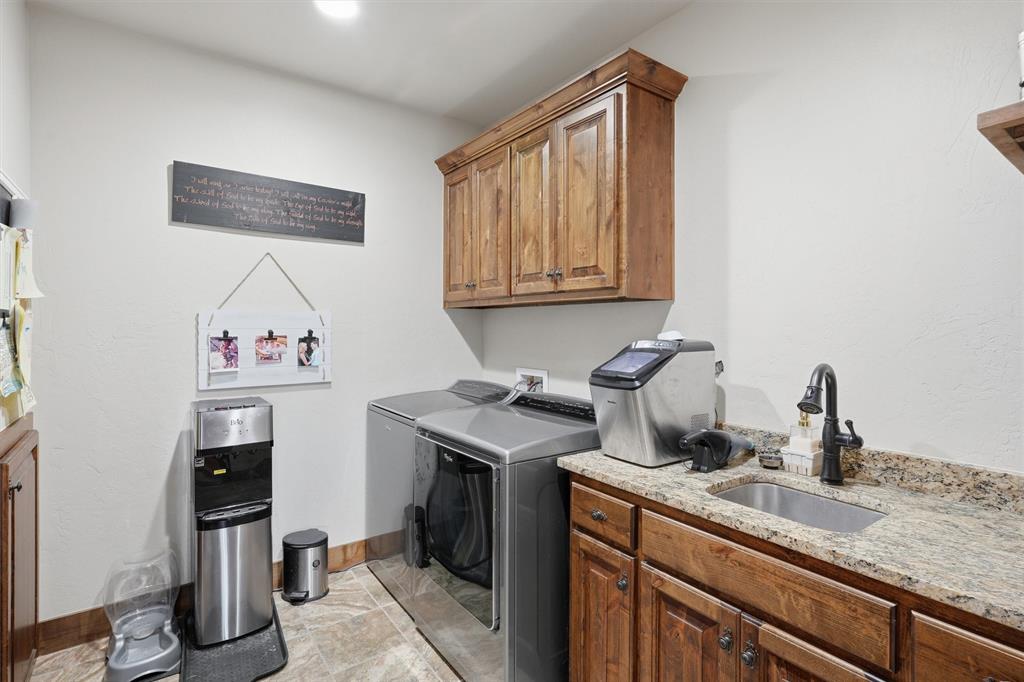 1080 Cascade Lane Graford, TX 76449 - Photo 27 of 39 a kitchen with stainless steel appliances granite countertop a sink stove and cabinets