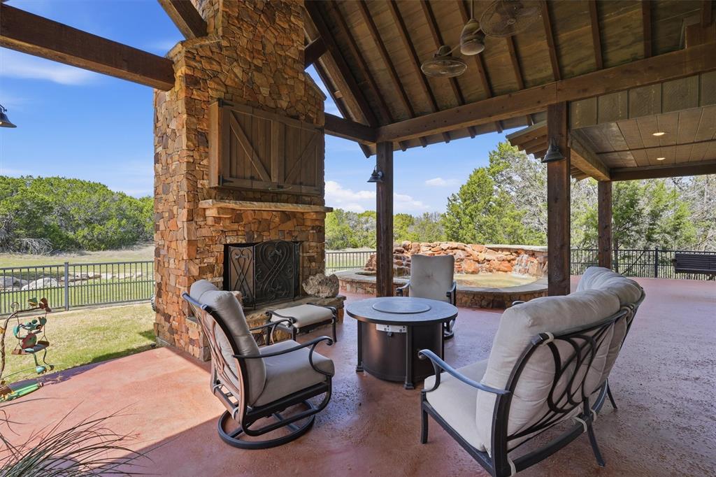 1080 Cascade Lane Graford, TX 76449 - Photo 29 of 39 a view of a patio with a table chairs and a floor to ceiling window