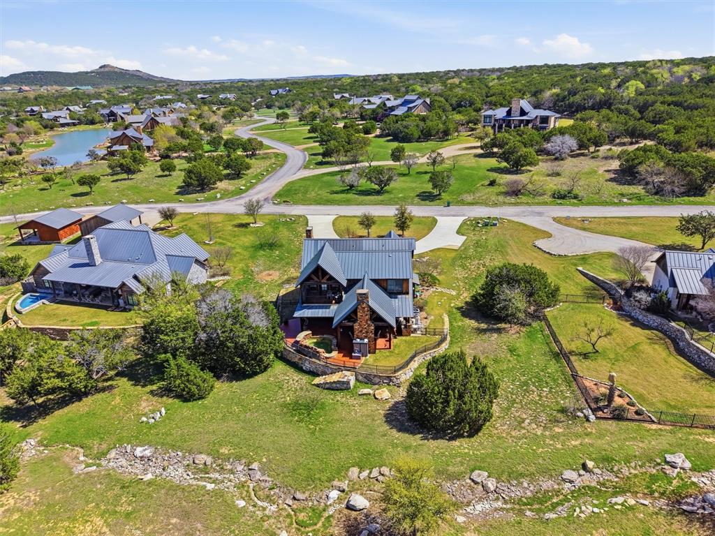 1080 Cascade Lane Graford, TX 76449 - Photo 32 of 39 an aerial view of a house with a garden and mountains in the background