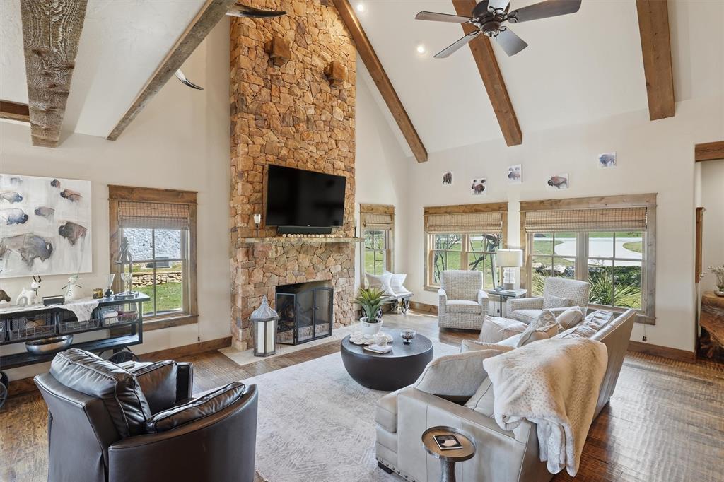 1080 Cascade Lane Graford, TX 76449 - Photo 4 of 39 a living room with furniture a fireplace and a floor to ceiling window