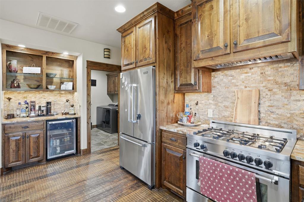 1080 Cascade Lane Graford, TX 76449 - Photo 10 of 39 a kitchen with stainless steel appliances granite countertop a stove a refrigerator and a stove