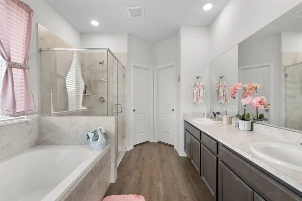 a spacious bedroom with a bed and a large window