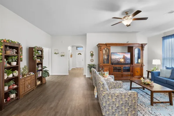 a living room with furniture and wooden floor