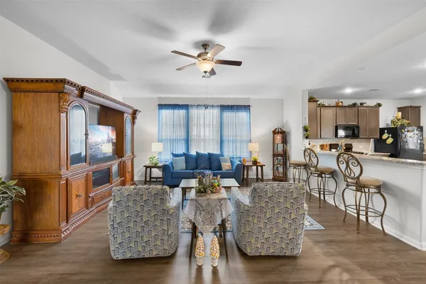 a living room with furniture and a lamp