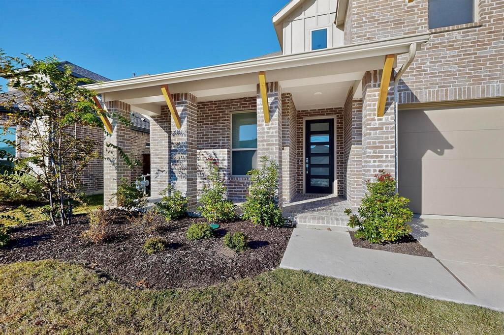 2017 Fall Crk Cove Mesquite, TX 75181 - Photo 2 of 40 Entrance to property featuring a porch, a garage, brick siding, and board and batten siding