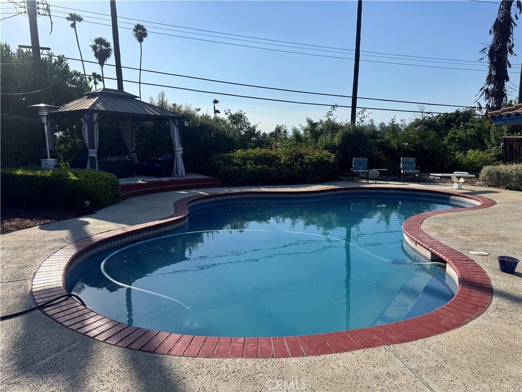 4967 Chapala Drive Riverside, CA 92507 - Photo 3 of 34 a view of a swimming pool with a patio