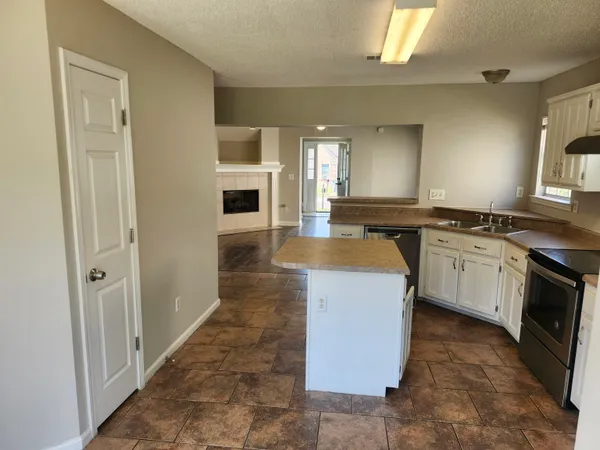 a kitchen with a sink stove and cabinets