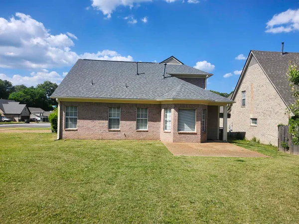 a front view of a house with a yard and porch