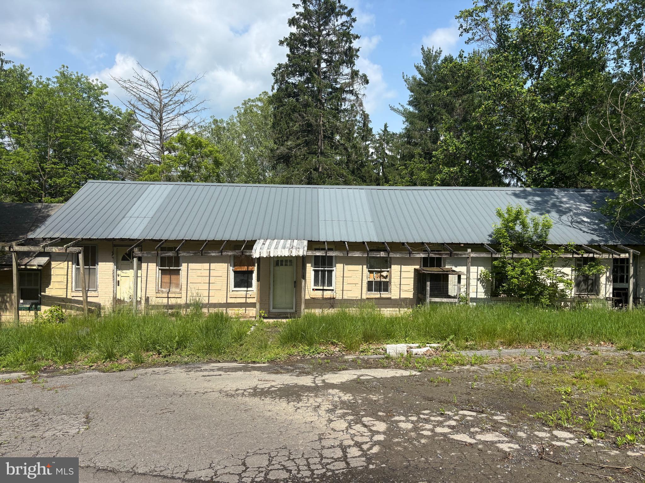 10105 Cottage Inn Lane Northeast Cumberland, MD 21502 - Photo 8 of 20 a front view of a house with a yard and potted plants