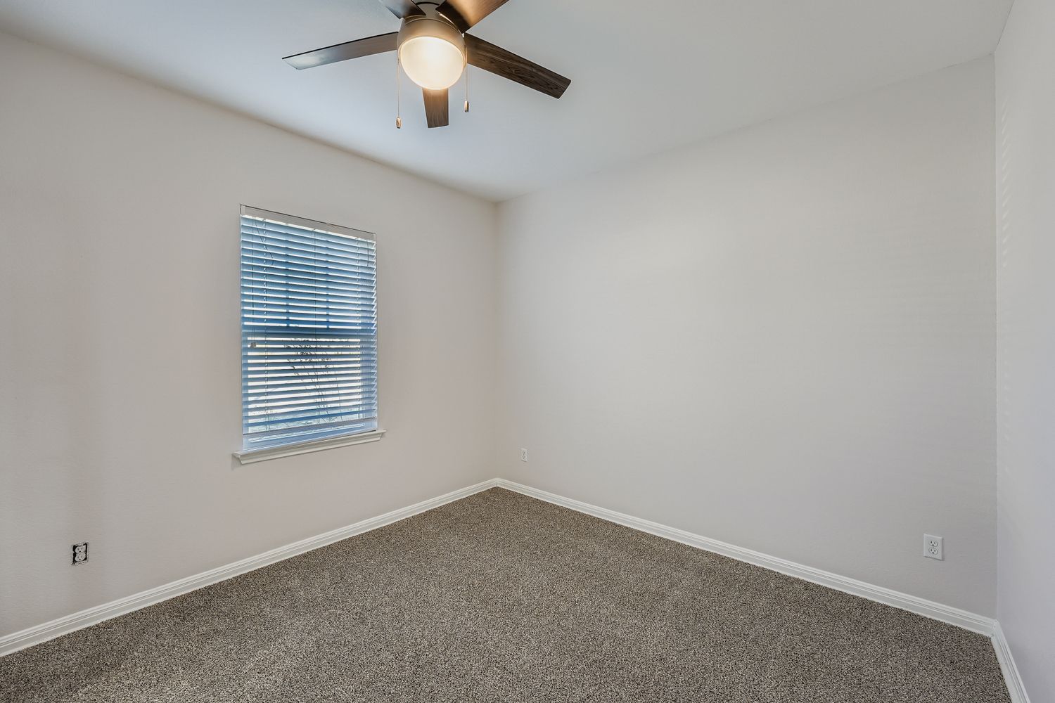 14013 Mark Christopher Way Manor, TX 78653 - Photo 10 of 28 an empty room with a window and a fan