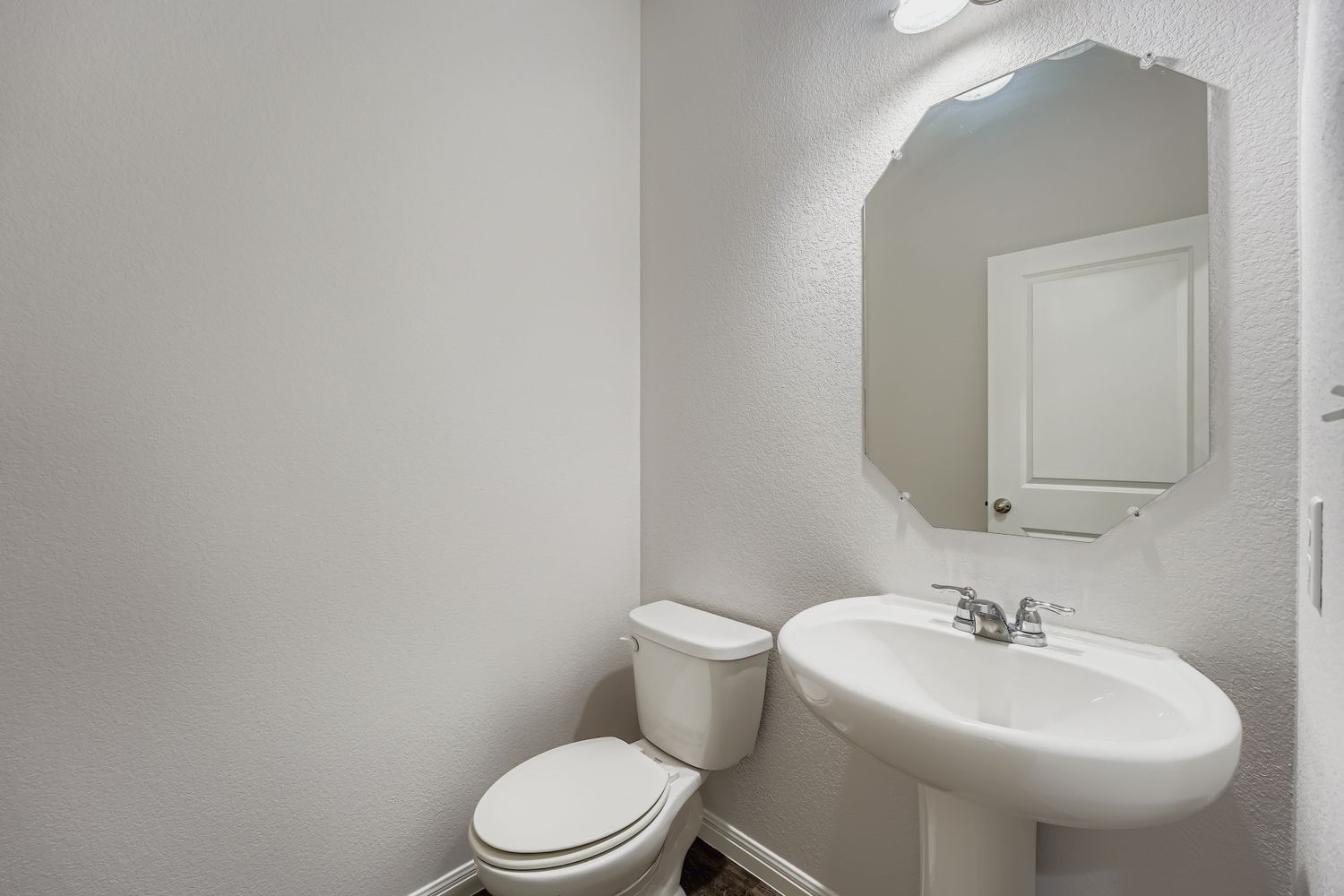 14013 Mark Christopher Way Manor, TX 78653 - Photo 11 of 28 a bathroom with a sink a toilet and mirror