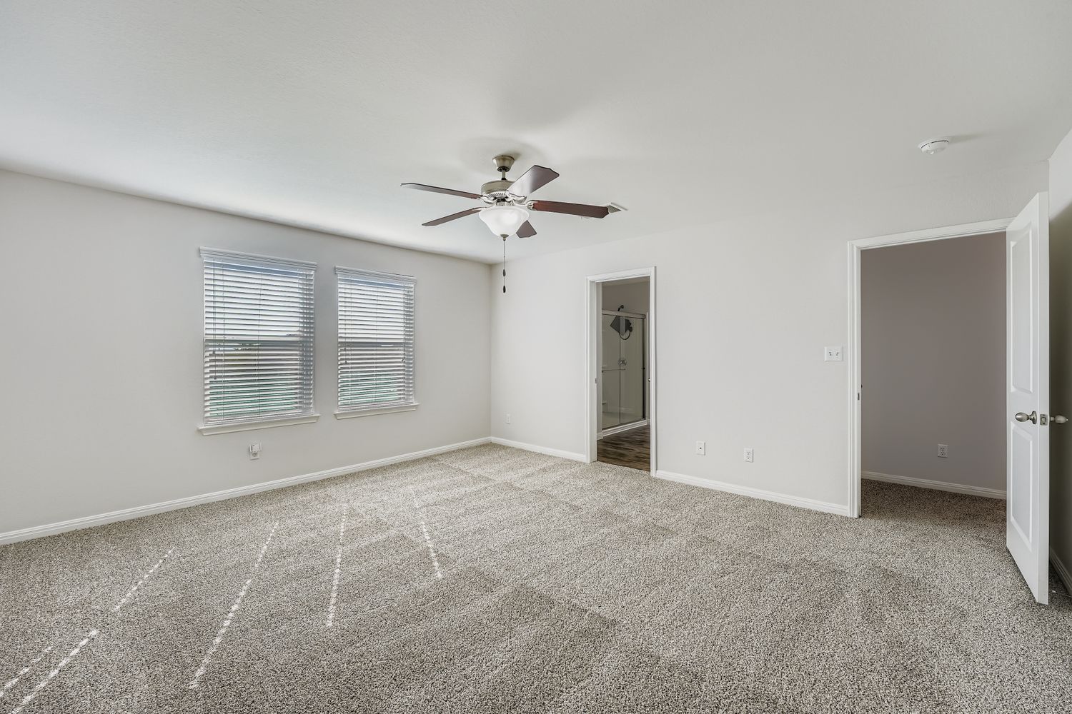 14013 Mark Christopher Way Manor, TX 78653 - Photo 13 of 28 a view of an empty room with a ceiling fan