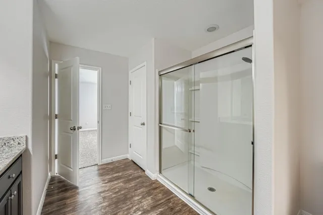 a bathroom with a shower and closet