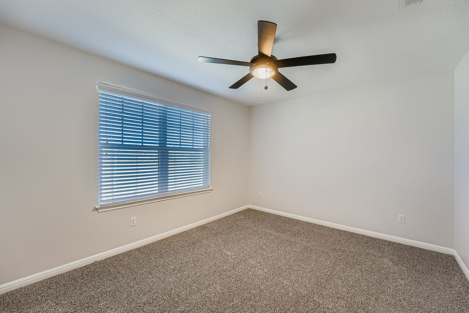 14013 Mark Christopher Way Manor, TX 78653 - Photo 17 of 28 an empty room with a window and a ceiling fan