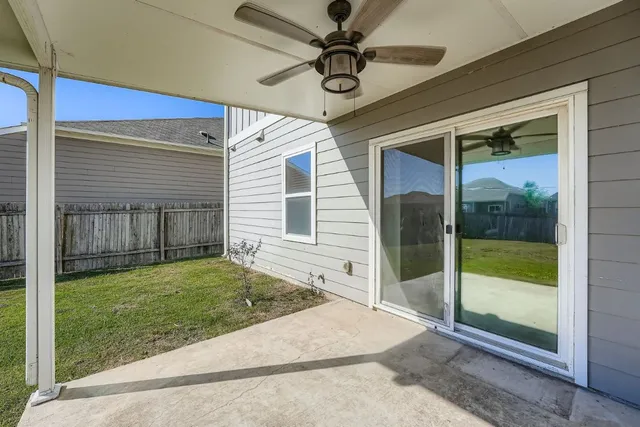 a view of a porch with a table and chairs
