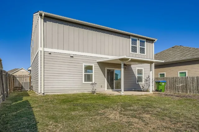 a view of a house with a backyard