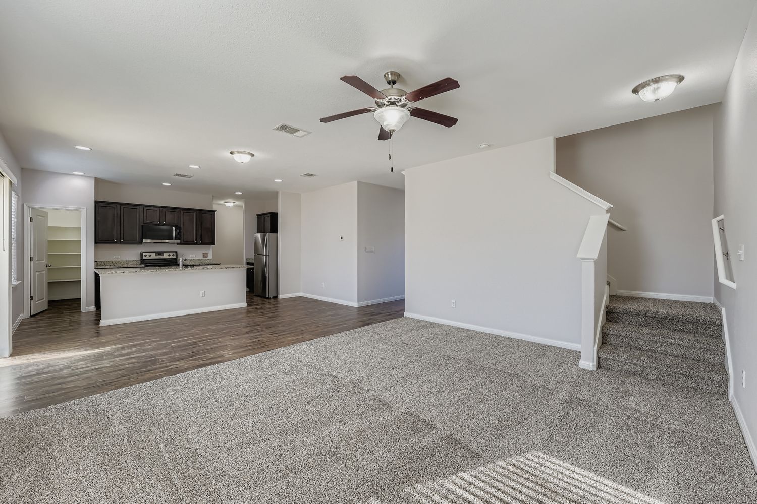 14013 Mark Christopher Way Manor, TX 78653 - Photo 5 of 28 a view of a kitchen with a sink and a refrigerator