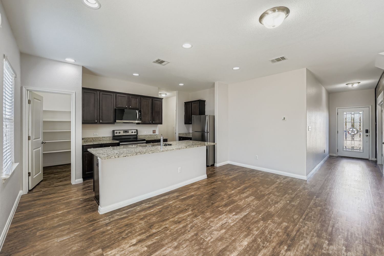 14013 Mark Christopher Way Manor, TX 78653 - Photo 28 of 28 a large kitchen with a large window and stainless steel appliances