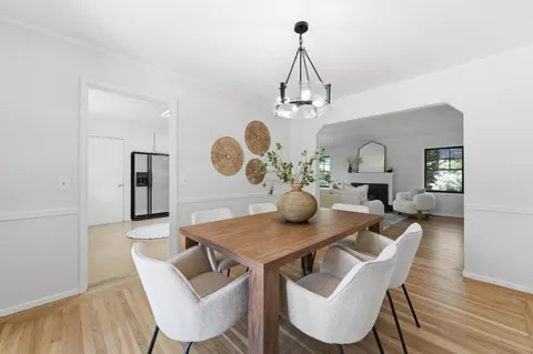 a view of a dining room with furniture and chandelier