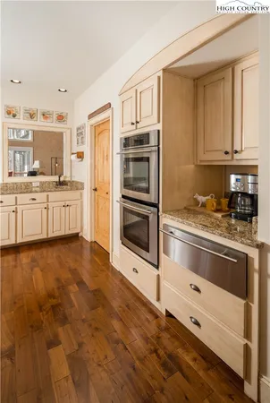 a kitchen with granite countertop a refrigerator stove top oven and sink