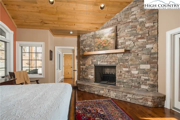 a spacious bedroom with a bed and a fireplace