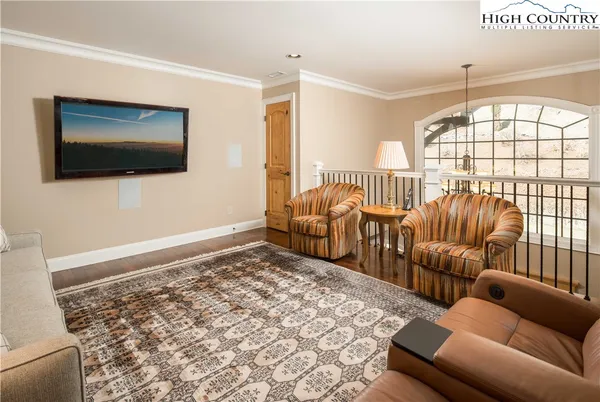 a living room with furniture tv and a window