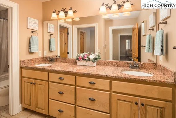 a bathroom with a double vanity sink and a mirror