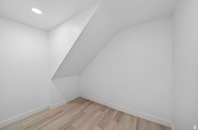 6969 South 855 East Midvale, UT 84047 - Photo 34 of 55 Recessed lighting illuminates this interior space featuring wood-finish flooring, white walls, and white baseboards