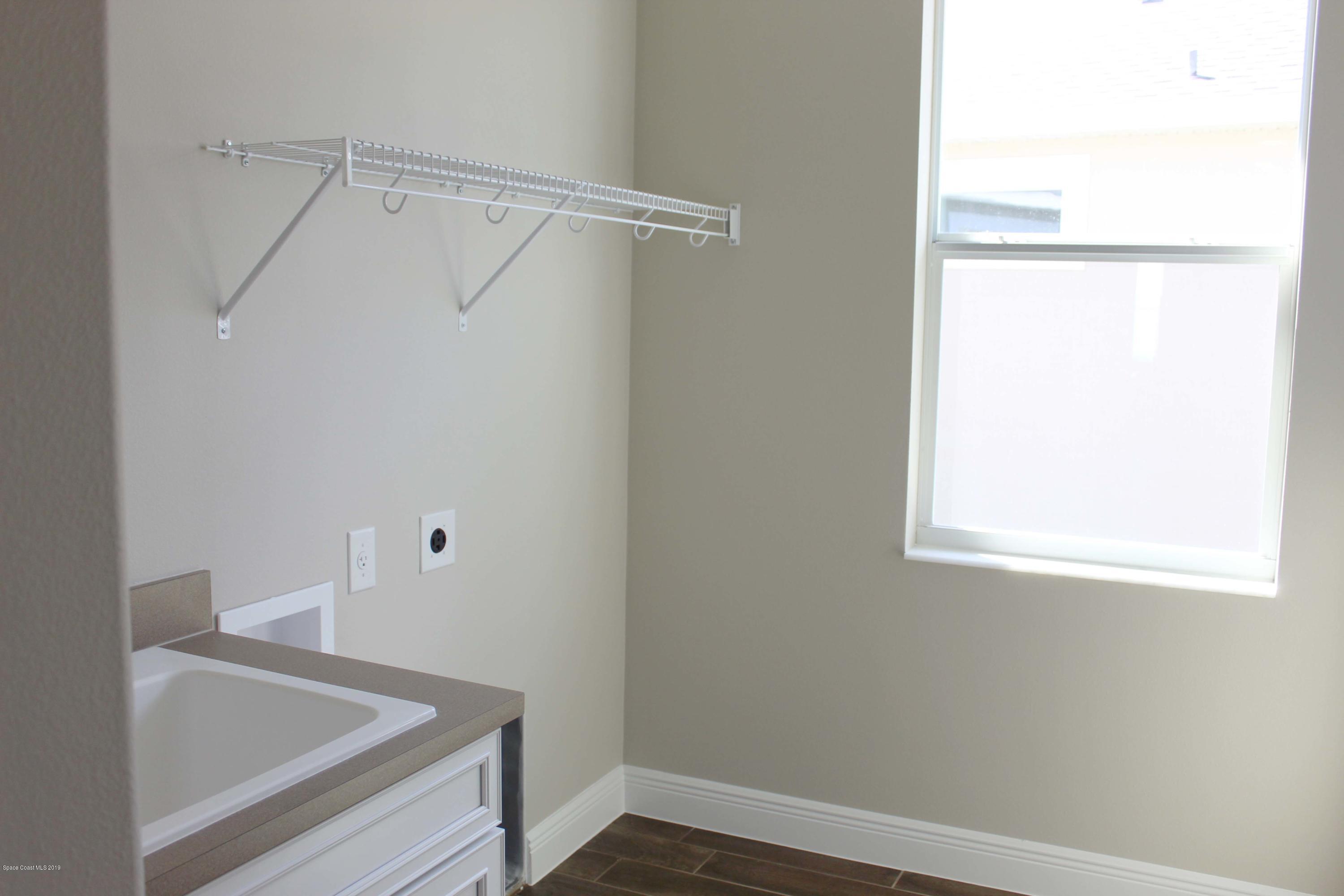 3631 Stabane Place Melbourne, FL 32940 - Photo 14 of 47 a view of small space with racks on the wall