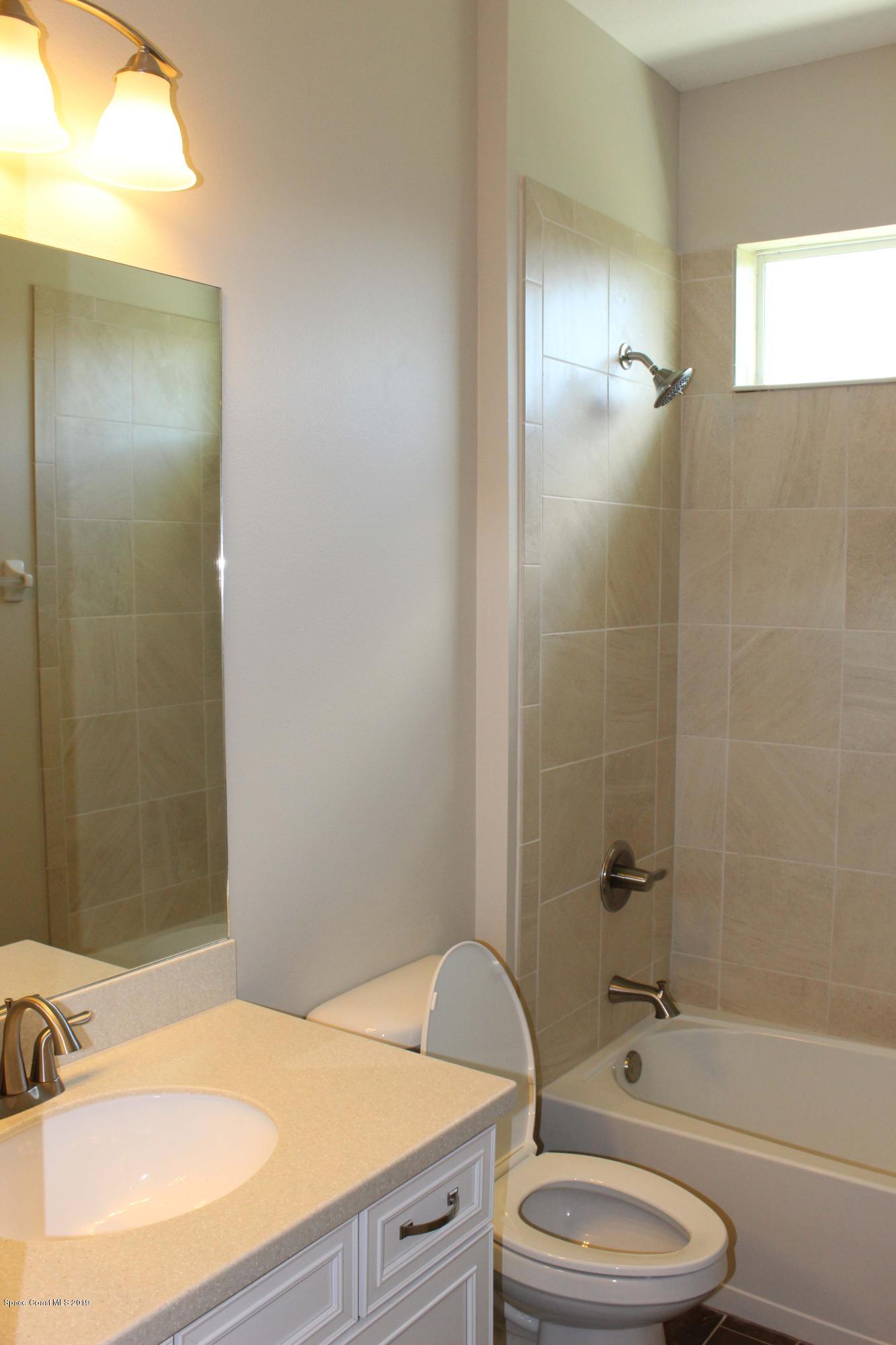 3631 Stabane Place Melbourne, FL 32940 - Photo 17 of 47 a bathroom with a granite countertop sink toilet and shower