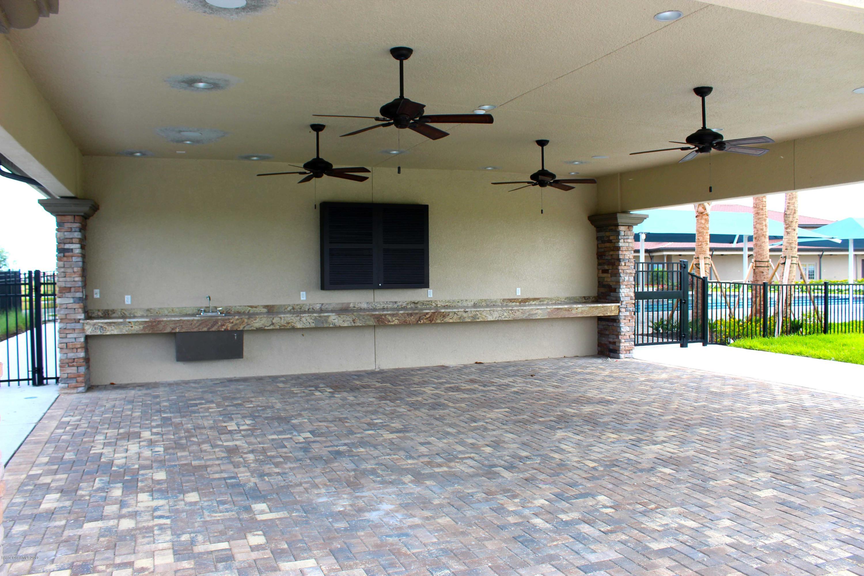 3631 Stabane Place Melbourne, FL 32940 - Photo 36 of 47 a view of a kitchen with a sink and a fireplace