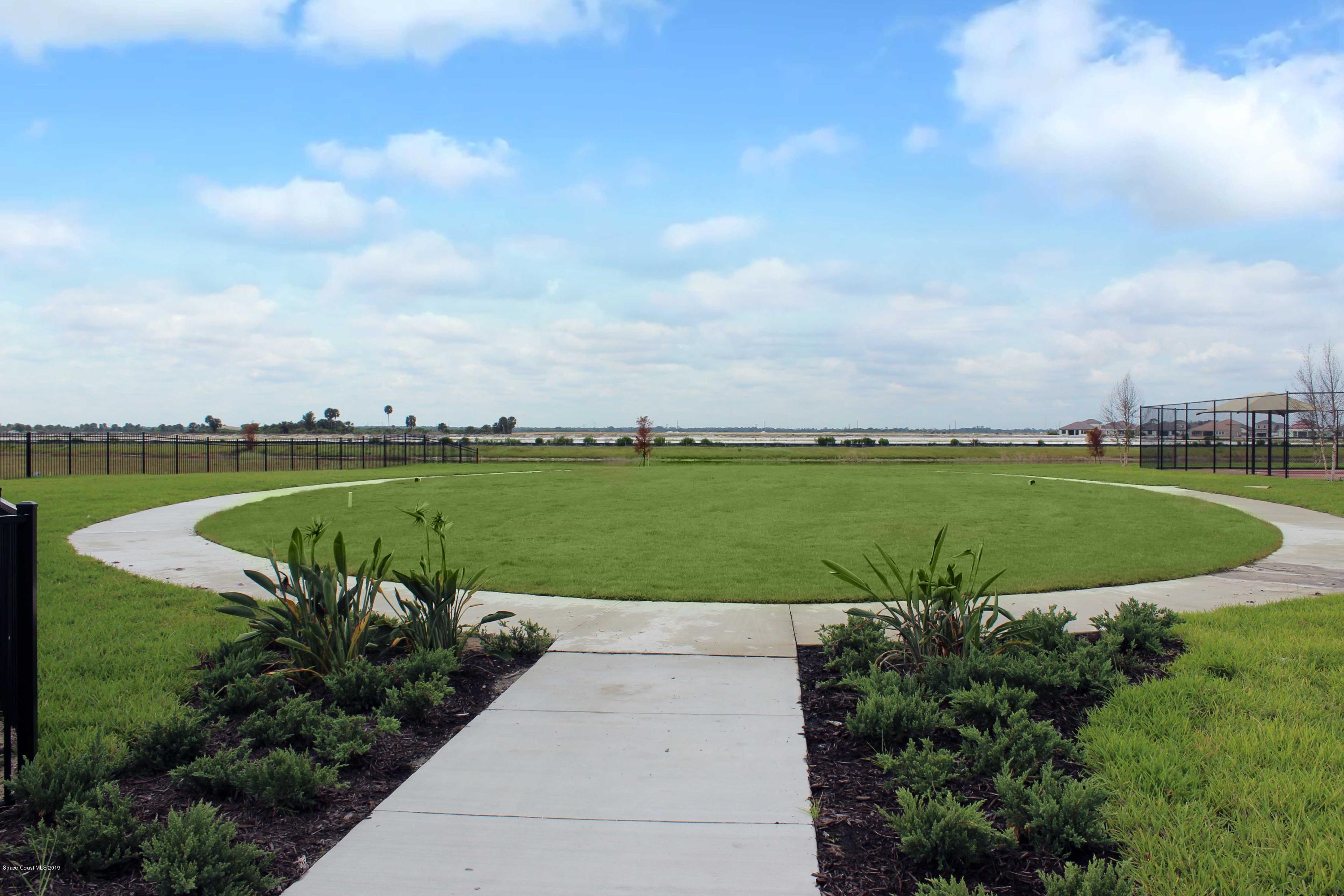3631 Stabane Place Melbourne, FL 32940 - Photo 39 of 47 a view of a lake with a garden