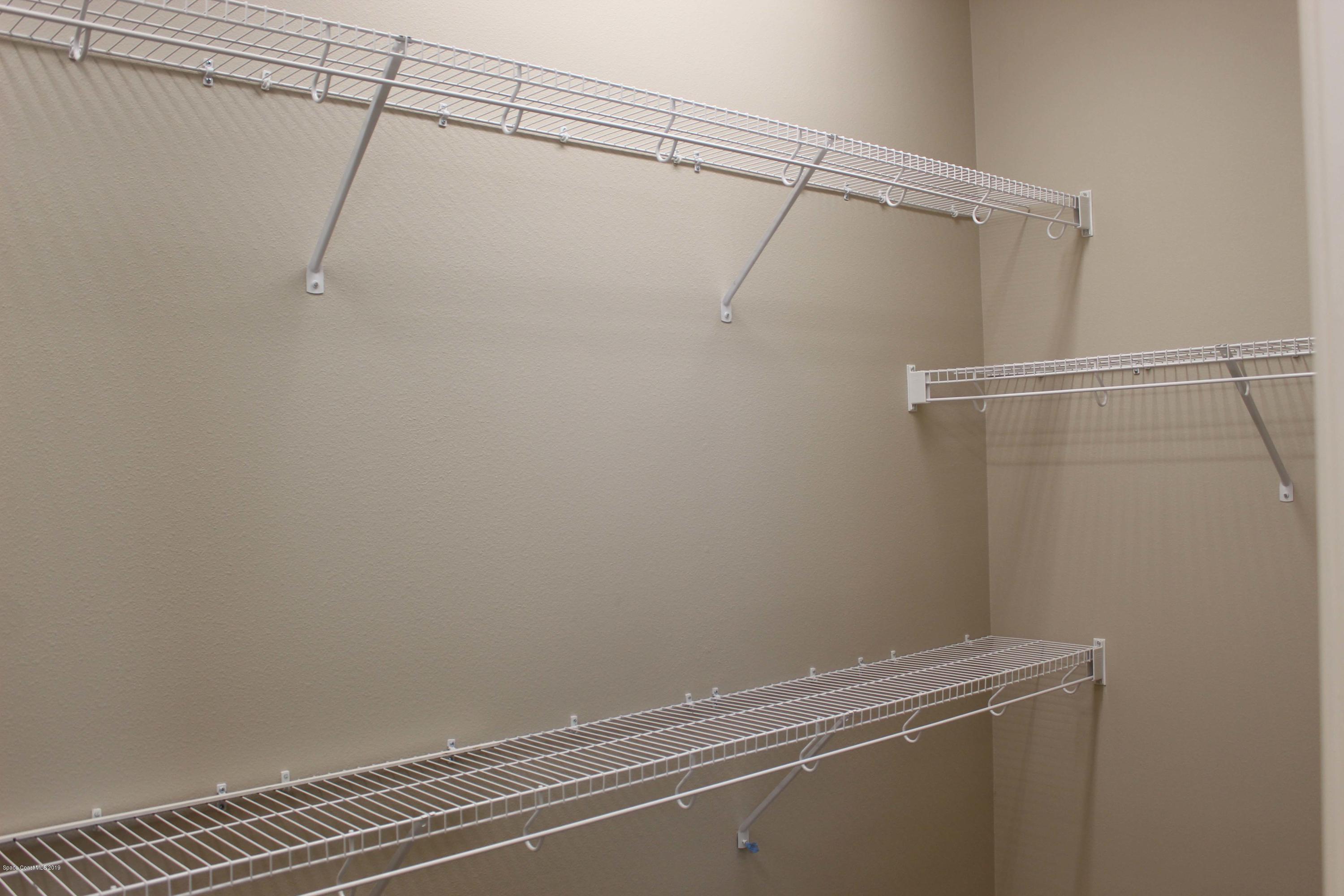 3631 Stabane Place Melbourne, FL 32940 - Photo 10 of 47 a view of a room with racks on the wall