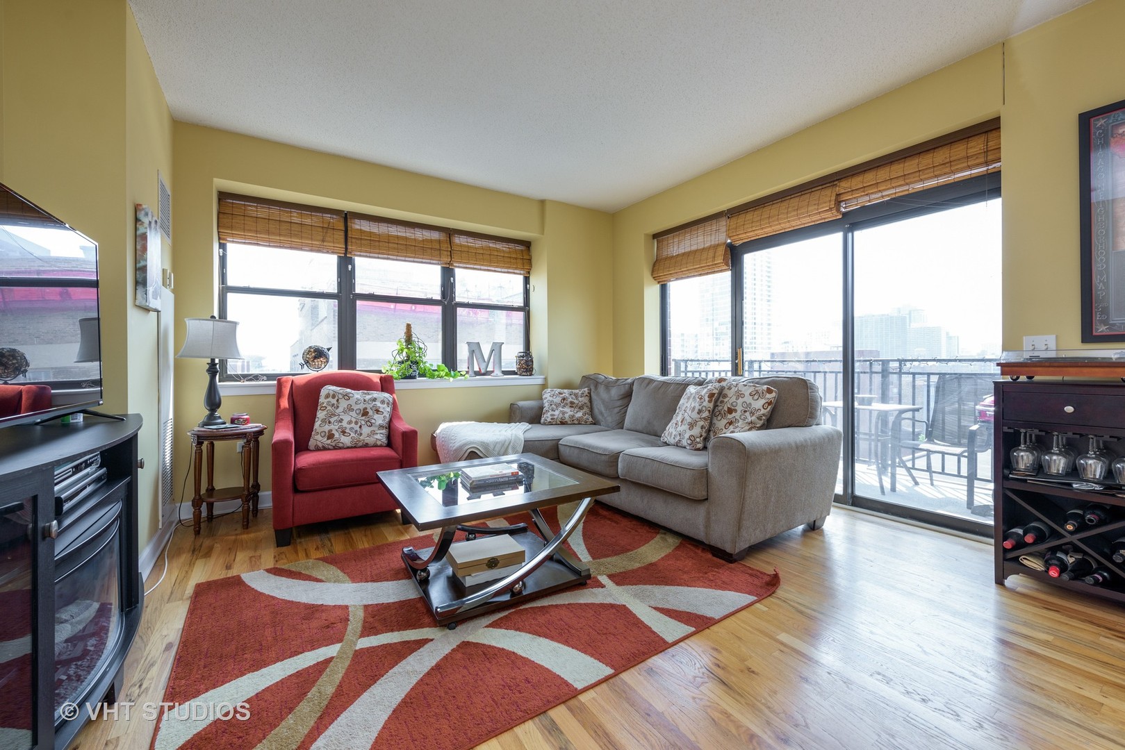 1529 South State Street, Unit 8B Chicago, IL 60605 - Photo 2 of 11 a living room with furniture and a floor to ceiling window next to a large window