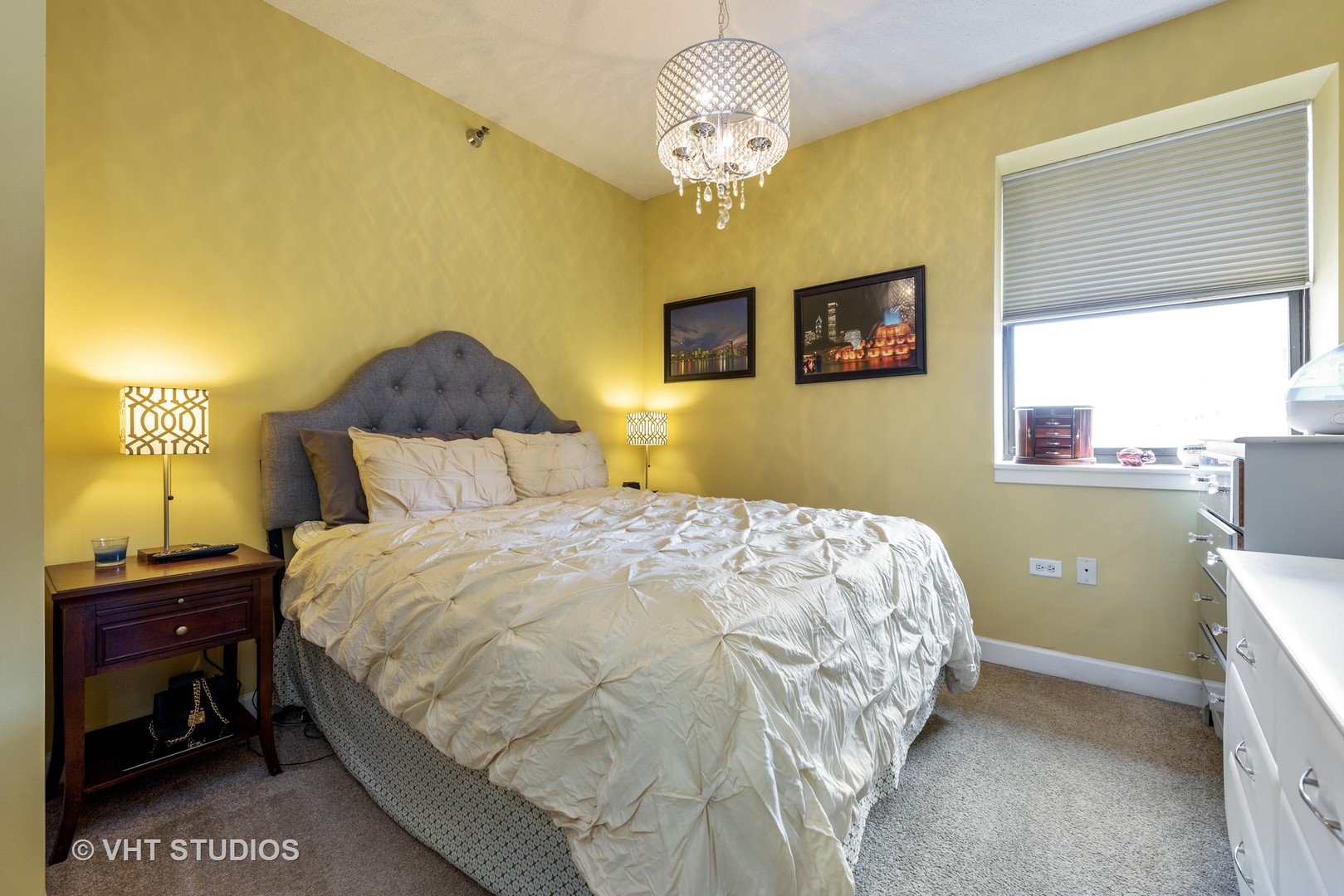 1529 South State Street, Unit 8B Chicago, IL 60605 - Photo 6 of 11 a bedroom with a bed and a chandelier