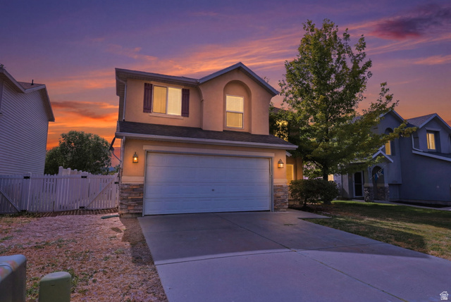 5485 Heather Way Tooele, UT 84074 - Photo 2 of 41 Two-story stucco exterior with stone accents, an attached two-car garage, and decorative window shutters