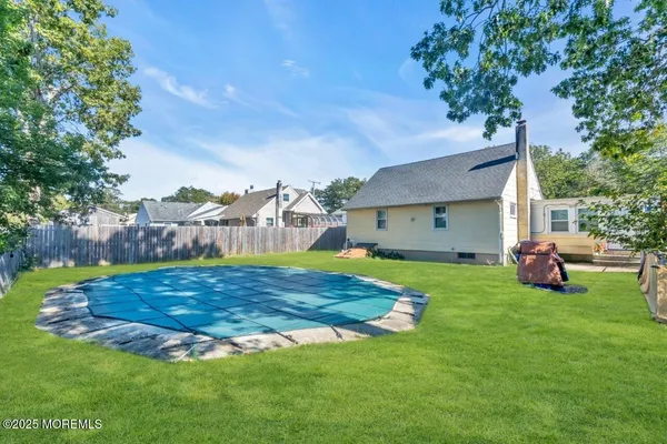a view of backyard with huge green area and large trees