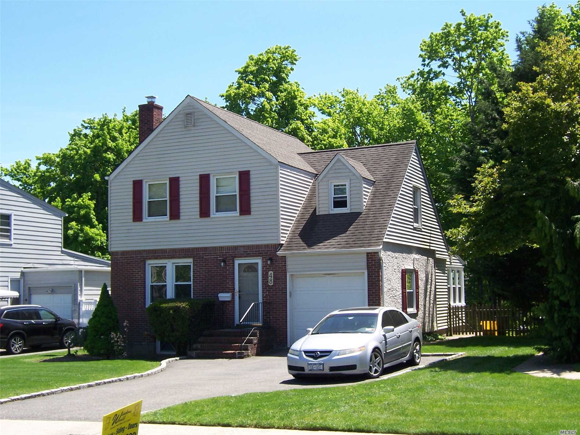 48 Jefferson Road Farmingdale, NY 11735 - Photo 1 of 1 a front view of a house with a yard and garage